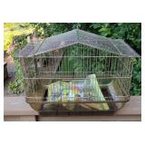 Vintage metal bird cage with a pitched roof
