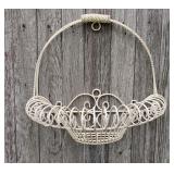 Vintage cream-colored wrought iron wall basket