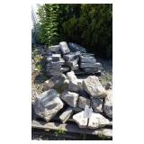 Grey flat stones on skid & large cement pieces