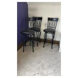 Three tall swivel chairs.