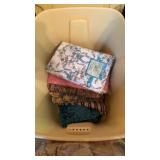 Tote with tablecloth and woven rugs and a