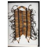 Old Bone Breast Plate w/metal beads displayed in a