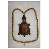 Hudson Bay Turtle Necklace displayed in a 12' X 16
