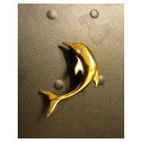 Gold colored dolphin pin signed 1.5 inches.