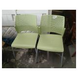 2 green patio chairs.
