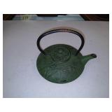 Green oriental iron teapot.