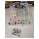 Box full of craft items, plastic case.