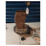Lighted water fountain with rocks needs bulb.