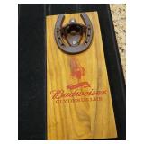Budweiser Clydesdale's bottle opener on wood.