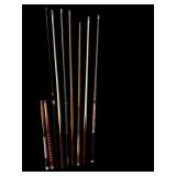 collection of various billiard pool cues