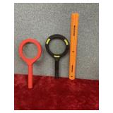 Red and black magnifying glass about 9 inches in