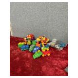 Toddler toys, little miniature trucks, a chick, a