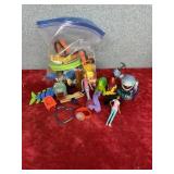 A bag full of various animals, toys dinosaurs,