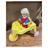 Vintage doll in baby walker