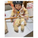 A vintage porcelain doll, Native American