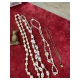 Three seashell necklaces, one gold necklace with