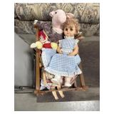 Assorted dolls with wooden crib
