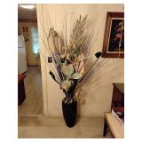 Large black ceramic vase with floral arrangement