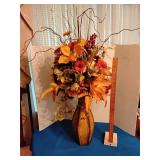 Metal vase with floral arrangement