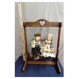 Porcelain Grandpa & Grandma in wooden swing
