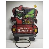 Metal Grinch in red tuck yard decor