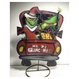 Metal Grinch in red tuck outdoor yard decor
