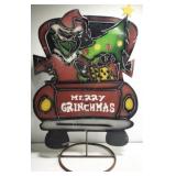 Metal Grinch in red tuck yard decor
