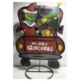 Metal Grinch in red tuck yard outdoor decor