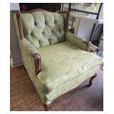 Green upholstered wing back chair