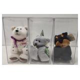 3 collectible plush toys in cases
