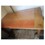 Wooden Table has a piece of plexiglass on it **
