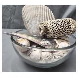 Glass bowl with sand and seashells