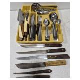 Silverware tray full of utensils and knives