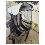 Green and black lawn chair with sun shade