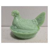 green hen on nest