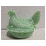 Green hen on nest
