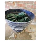 Flower pot with a coil style water hose