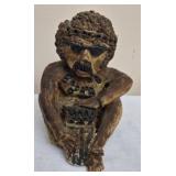 dark stone statue may be Egyptian God Bes