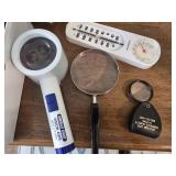 Magnifying glasses and thermometer