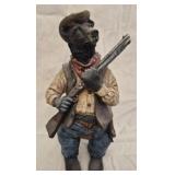 black bear dressed as a cowboy holding a rifle