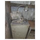 Industrial grinder on cabinet