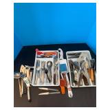 2 white trays of utensils