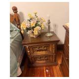 Bedside table, lamp, basket of flowers