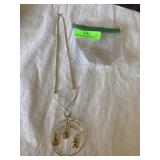 Gold tone necklace with hanging charm pendant, 14