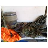 Camping bucket filled with camo vests, assorted