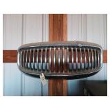 Chrome grill out of an old Hudson has damage