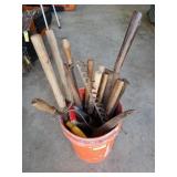 Orange 5 gallon bucket filled with old wood