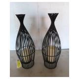Pair of black metal candle holders, 20 in tall