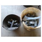 5 gallon bucket bursting with chain link fence