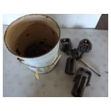 Metal 5 gallon bucket filled with old pulleys